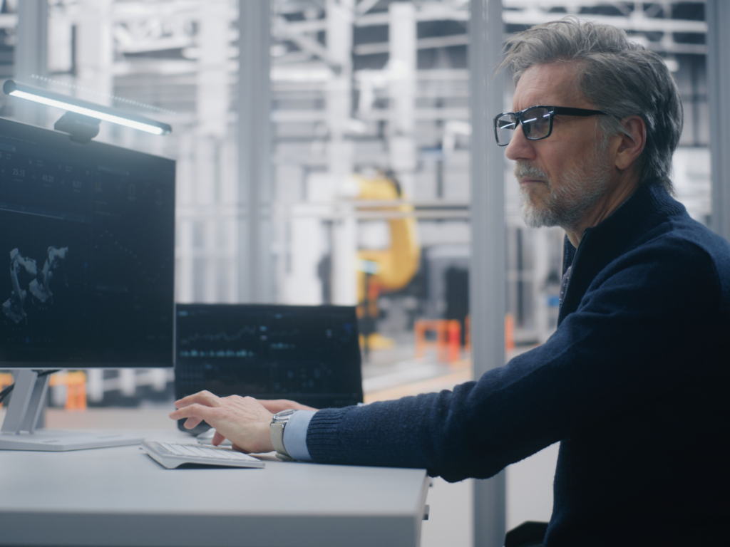 Old man building and programming an application