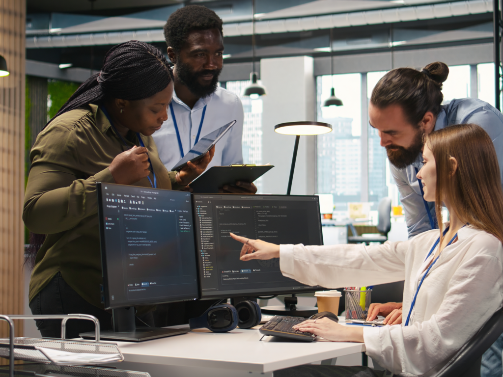 Team member discusses and shows code to the rest of the team