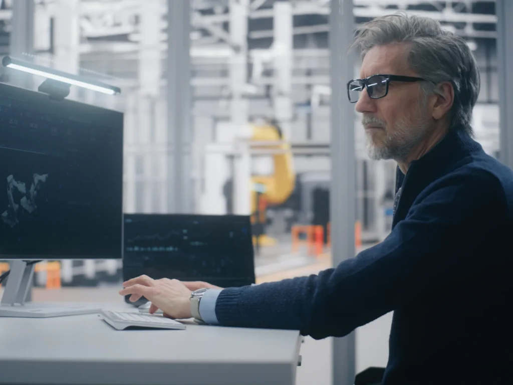 Old man building and programming an application